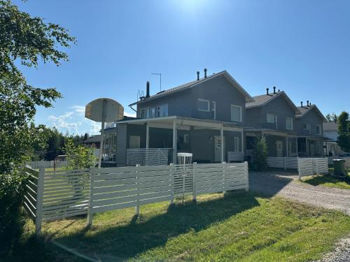 a house with a white fence in front of it at Virpiniemen Maston Villa, Oulu in Oulu