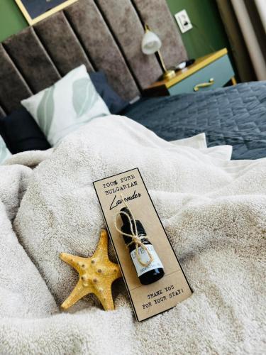 a book sitting on top of a bed with a starfish at Blue Bay House in Nesebar