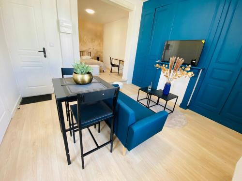 a blue living room with a blue couch and a table at Le Saphir Zénith 1 in Amiens