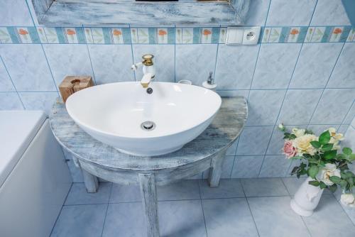 a bathroom with a white sink on a table at Willa pod Jemiołą in Wisła