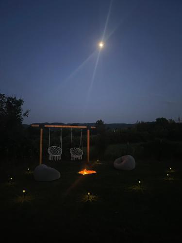 a night view of a campfire and a bonfire at Deda Momirov zavičaj in Tulež