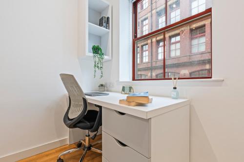 a white desk with a chair and a window at Leeds Elegant Central Flat - Sleeps 8 - View City Centre in Central Station