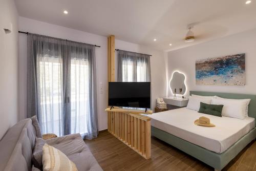 a bedroom with a large bed and a flat screen tv at Aphrodite's Refuge in Galissas