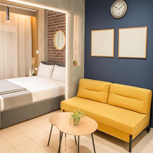 a living room with a bed and a couch at GpxClr-Come Undone Suite in Larisa