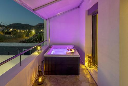 a bathroom with a bath tub on a balcony at Aphrodite's Refuge in Galissas
