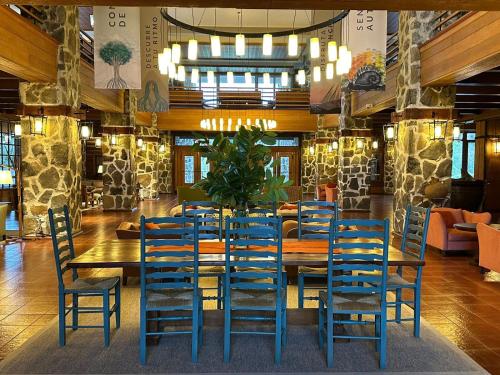 a dining room with a table and chairs at Hotel Termas Puyehue Wellness & Spa Resort in Puyehue