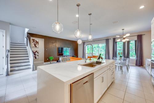an open kitchen with white countertops and a dining room at Less Than 20 Mi to JAX Beach and Game Days Upscale Retreat in Pine Bluff
