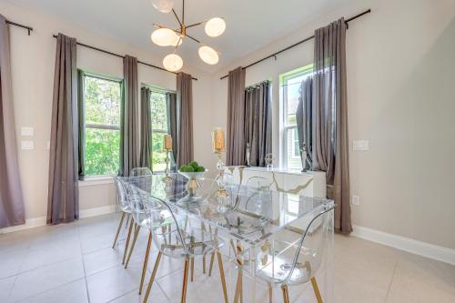 a dining room with a glass table and chairs at Less Than 20 Mi to JAX Beach and Game Days Upscale Retreat in Pine Bluff