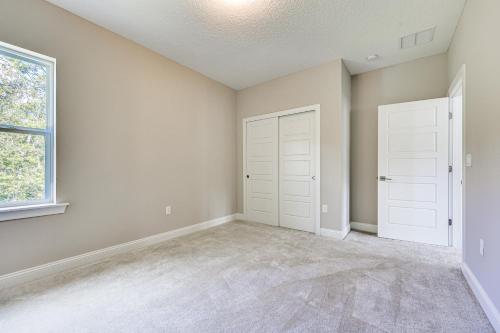 an empty room with white doors and a window at Less Than 20 Mi to JAX Beach and Game Days Upscale Retreat in Pine Bluff