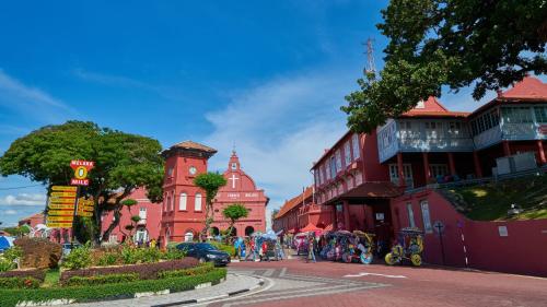 a street in a town with red buildings at Holiday Inn Melaka by IHG in Melaka