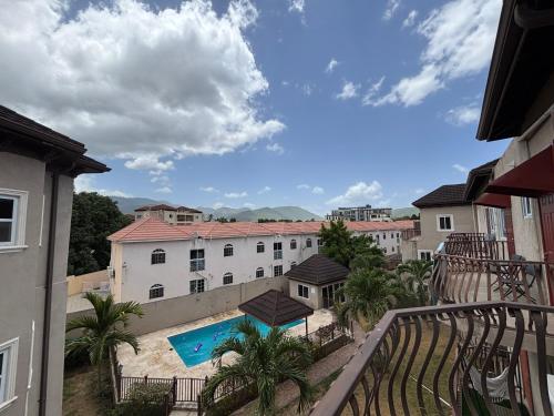 a view from the balcony of a hotel with a swimming pool at Casa Pors Luxury Apartment with Security, Pool, & Gym in Liguanea