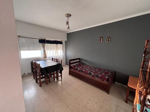 a living room with a table and chairs and a couch at Departamento céntrico in Mar del Plata