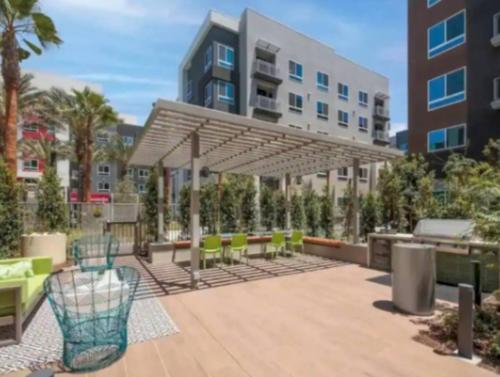 a patio with tables and chairs under a canopy at Cozy 2bd Apt Near Disneyland Anaheim Conv Center in Anaheim
