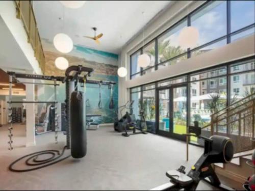 a gym with cardio equipment in a large room with windows at Cozy 2bd Apt Near Disneyland Anaheim Conv Center in Anaheim