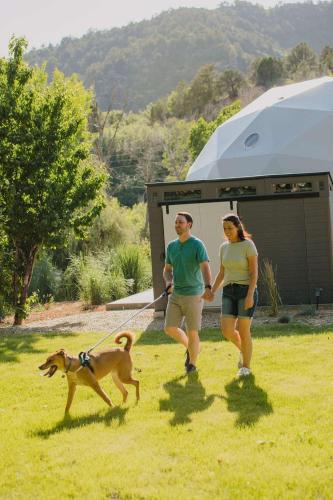 a man and woman walking a dog on a leash at 2 domes in Glendale Utah Fantastic Stargazing in Glendale