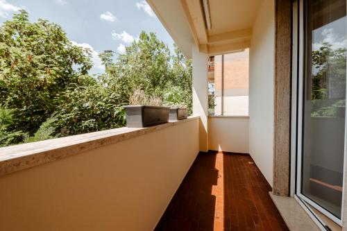 an empty balcony with a large window at Independent Rooms in Verona