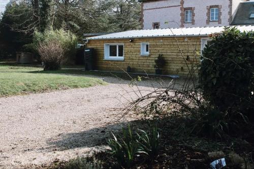 a house with a gravel driveway in front of it at Chambre indépendante avec salle de bain et toilettes in Romilly-sur-Andelle