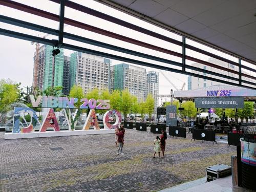 a group of people walking down a street in a city at Juvycondo in Davao City