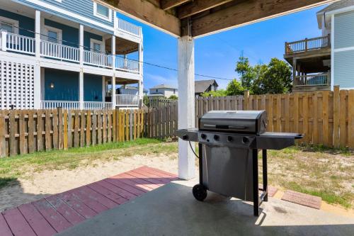 a grill in the backyard of a house at 5115 - Salt Therapy in Kill Devil Hills