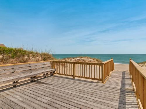 a wooden boardwalk to the beach with two benches at 7030 - Explorers Beacon in Whalebone