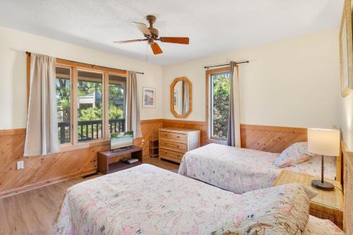 a bedroom with two beds and a ceiling fan at 2030 - Horizon`s Summit in Duck