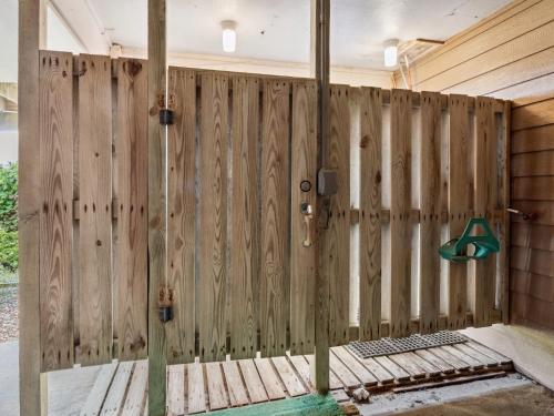 a wooden fence in a room with a door at 2030 - Horizon`s Summit in Duck