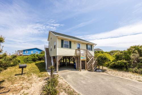 a house on the beach with a driveway at 7097 - Kickin` Back in Nags Head
