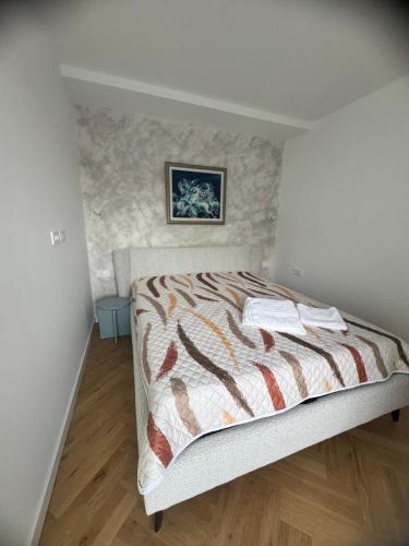 a bedroom with a bed with a stone wall at Grand Lake View Apartment in Ohrid