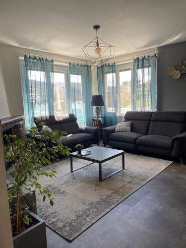 a living room with a couch and a coffee table at Maison familiale in Lacaune