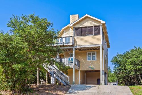 a large yellow house with a balcony at 1680 - Hopes and Dreams in Poplar Branch