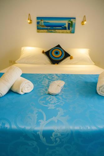 a bed with two towels on top of it at SantoNight Luxury Villas in Santorini
