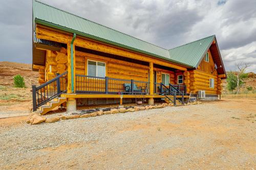 a large wooden cabin with a green roof at Explore Uintah Basin Rustic Cliff Cabin with Loft in Fort Duchesne