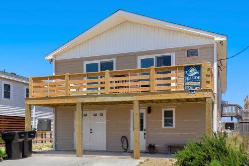 a house with a deck on top of it at 4122 - Blue White Haven in Kitty Hawk