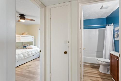 a small bathroom with a bed and a toilet at SO5A - Oceanside Bungalow in Kill Devil Hills