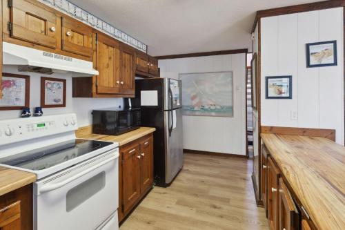 a kitchen with a stove and a refrigerator at 2029 - Duck Yeah in Duck