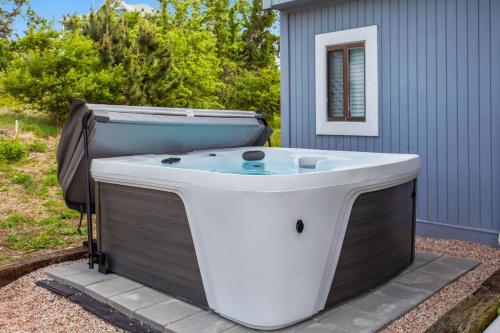 a bath tub sitting next to a building at 2029 - Duck Yeah in Duck