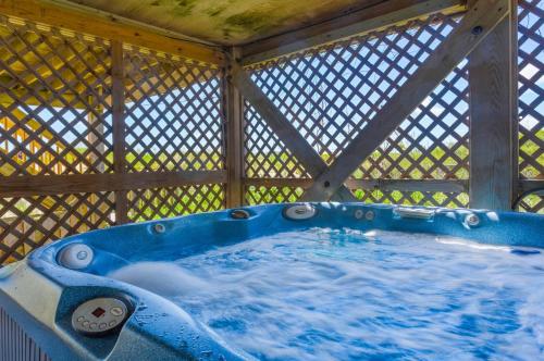 a blue hot tub in a gazebo at 7083 - Ocean Haven in Nags Head
