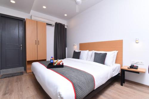 a bedroom with a large bed in a hotel room at Townhouse Rudra Inn Near Chhatarpur Metro Station in New Delhi