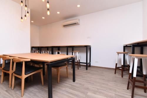 a dining room with wooden tables and chairs at Townhouse Rudra Inn Near Chhatarpur Metro Station in New Delhi