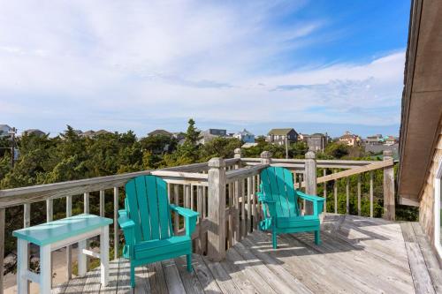 two chairs sitting on the deck of a house at 8074 - Sea Glass Charmer in Avon