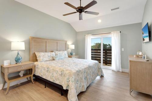 a bedroom with a bed and a ceiling fan at BCW30A - Waves Inn in Corolla