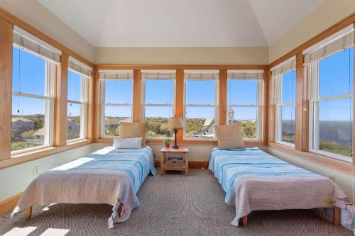 two beds in a room with windows at 8650 - Mare Vista Retreat in Frisco
