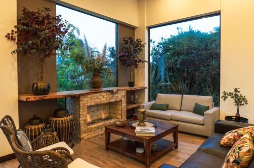 a living room with a couch and a fireplace at La Dolce Vita, Guatavita in Guasca