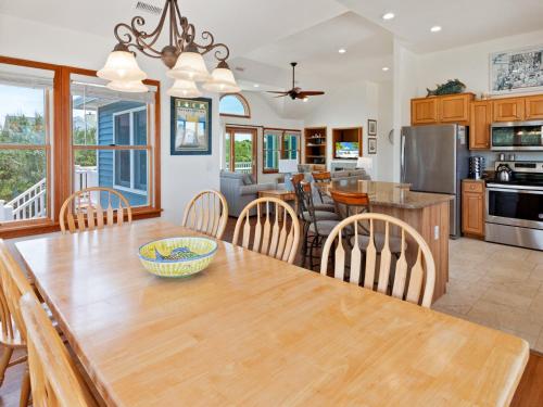 a kitchen and dining room with a wooden table and chairs at 2072 - Laughing Duck in Duck