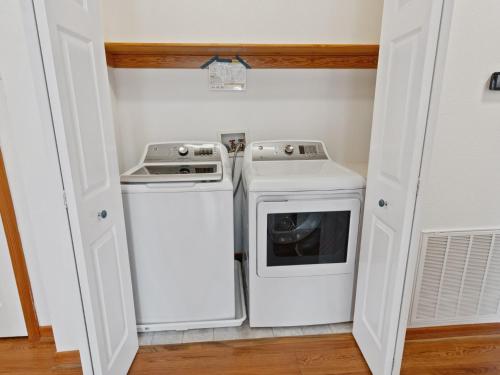 a small laundry room with a washer and dryer at 2072 - Laughing Duck in Duck