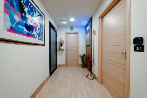 a hallway with a door and a painting on the wall at Independent Rooms in Verona