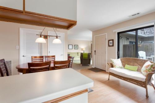 a kitchen and living room with a table and chairs at SC302 - Kitty Hawk Flyer in Kitty Hawk