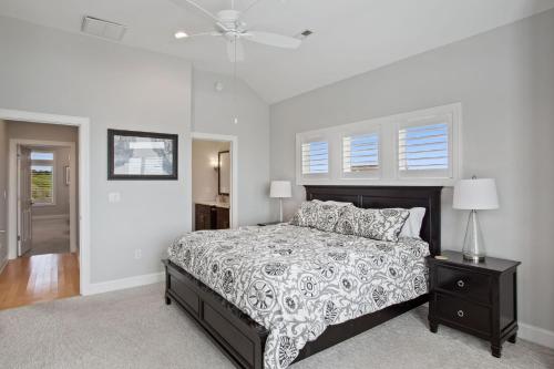 a bedroom with a bed and a ceiling fan at 3025 - Who's On First in Southern Shores