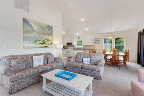 a living room with two couches and a table at 2027 - Sunny Lagoon in Sanderling