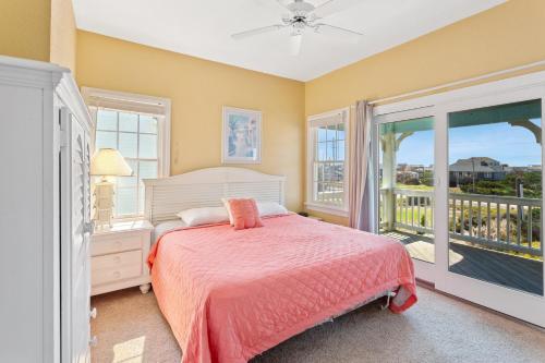 a bedroom with a bed and a balcony at 8046 - Sun Runner in Rodanthe